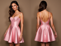 Blush pink satin mini dress with glitter lace bustier and flared pleated skirt.