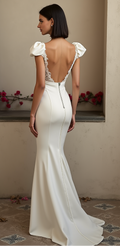 Chic mermaid bridal gown featuring an open-back lace-trimmed design, statement puff sleeves, and a fitted waist – a stunning mix of vintage and modern style. | فستان زفاف أنيق بظهر مكشوف مزين بالدانتيل وأكمام منتفخة وقصة ضيقة تبرز القوام | Vestido de novia con espalda descubierta, detalles de encaje y mangas abullonadas – sofisticado y glamuroso. | Robe de mariée sirène avec dos en dentelle, manches volumineuses et silhouette ajustée – idéale pour une mariée raffinée et audacieuse.